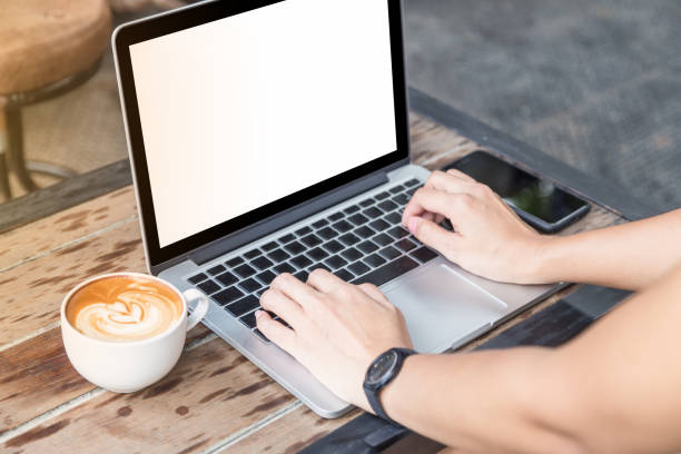 istock woman hand on laptop with mobile phone and coffee 685668042