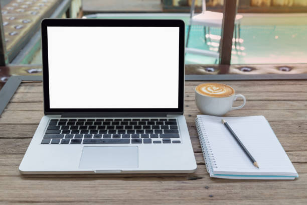 istock laptop, blank notepad and coffee on wood table 685668216
