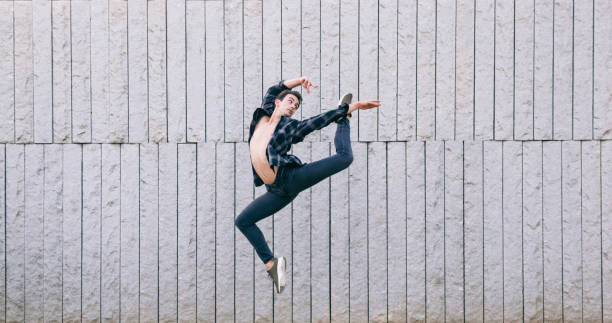 istock young male dancer jumping isolated on a grey wall 685668694