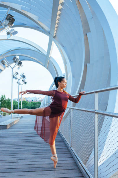 istock woman ballerina dancer stretching on a modern bridge 685668788