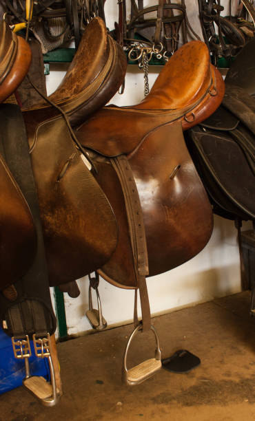 istock saddle with stirrup on the horse stable 685675928