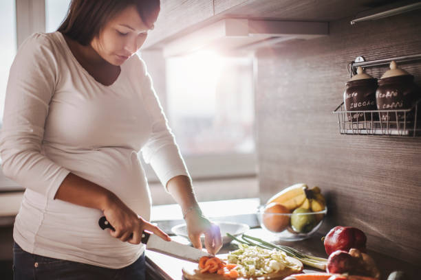 istock Pregnant woman making a salad 685689012