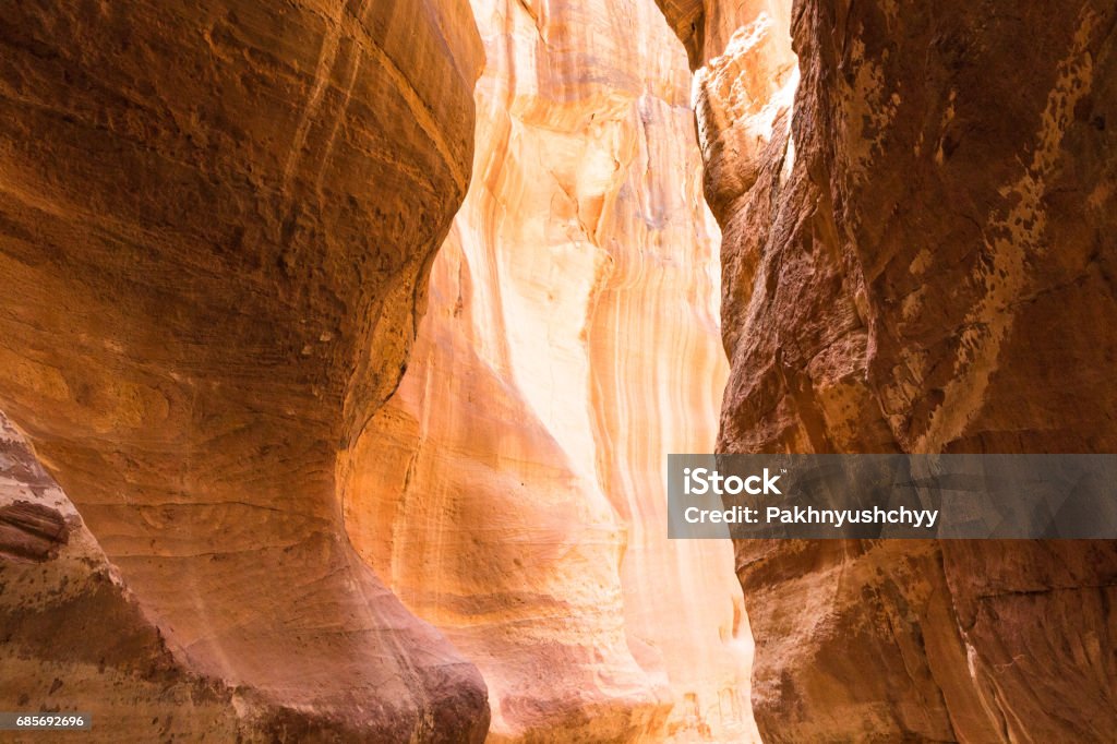 The Siq, the narrow slot-canyon The Siq, the narrow slot-canyon that serves as the entrance passage to the hidden city of Petra, Jordan, Ancient Stock Photo