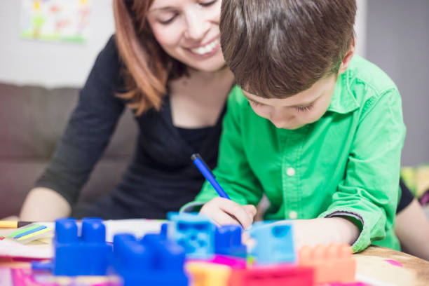 istock Happy mother and son colouring together 685725854