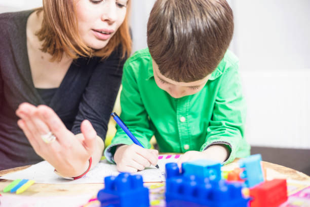 istock Happy mother and son colouring together 685725858
