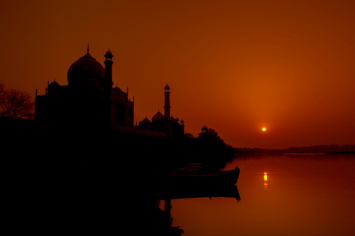 View of stunning and Magnificent monument of love Taj Mahal during sunset from the bank of river Yamuna at Agra, India.