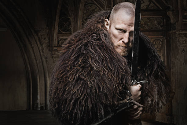 istock Sword wielding bloody viking warrior in studio shot 685736090