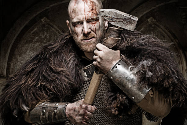 Hammer wielding bloody viking warrior in studio shot