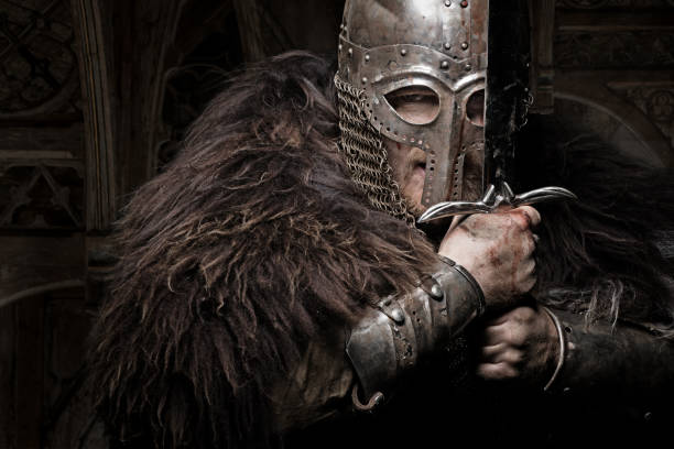 istock Sword wielding bloody viking warrior wearing an old helmet 685736286