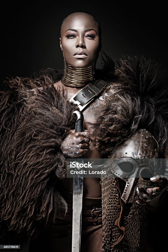 Beautiful black warrior princess holding a sword in studio shot Warrior - Person Stock Photo