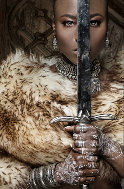 istock Beautiful black warrior princess holding a sword in studio shot 685740672