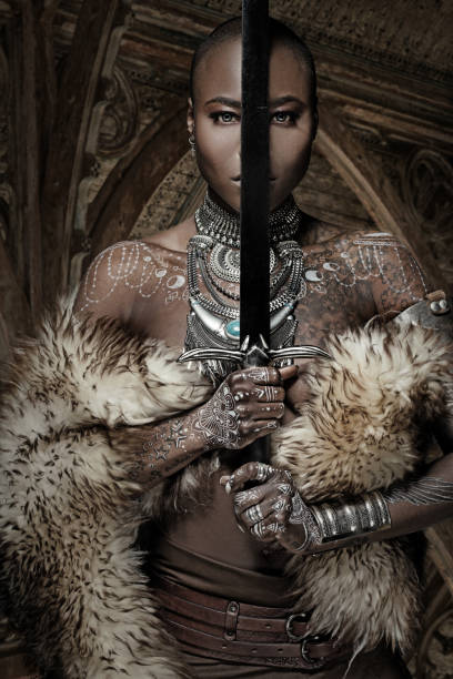 istock Beautiful black warrior princess holding a sword in studio shot 685740700