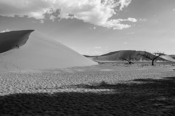 istock Two Women Walking up Dune 45, Desert Landscape, Sossusvlei, Namibia 685741090