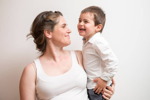 istock pregnant mother playing with her young son 685754480