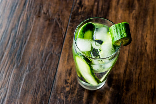 istock Cucumber Cocktail with vodka and tonic on dark wooden surface. 685756284