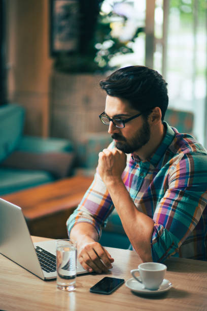 istock Young  casual man using laptop in modern cafe. 685756704