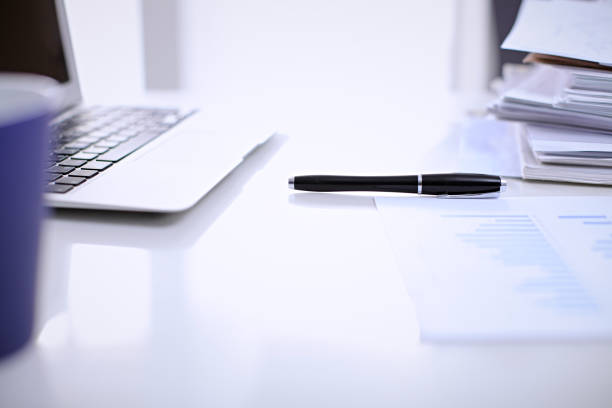 istock Office workplace with a laptop and financial documents 685757124