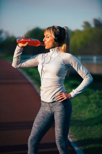 istock Female athlete drinking water after jogging 685757624
