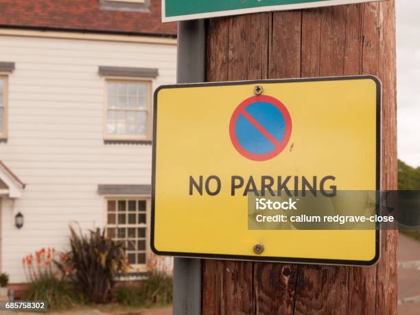 A Yellow Warning Traffic Sign Outside Saying No Parking Allowed Stock Photo - Download Image Now