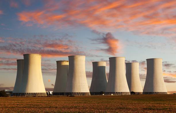 evening colored sunset view of nuclear power plant - blue cloudscape contemporary electricity imagens e fotografias de stock