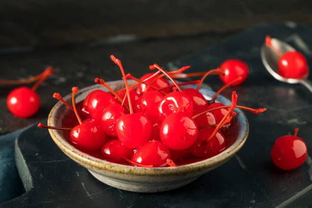 Sweet Red Maraschino Cherries Sweet Red Maraschino Cherries in Sticky Syrup maraschino cherry stock pictures, royalty-free photos & images