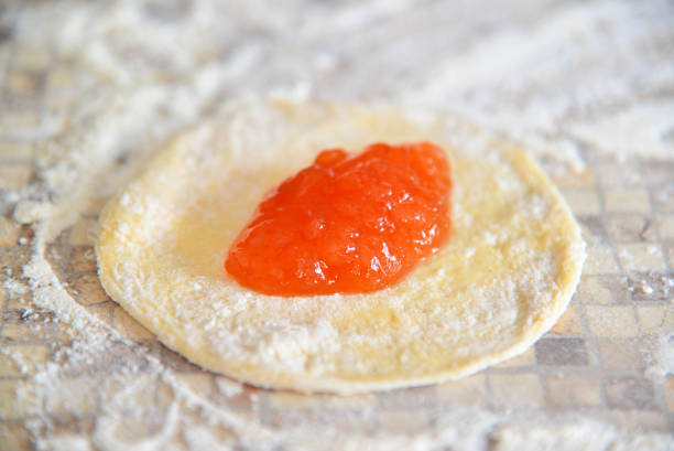 istock Apricot jam on dough for preparation of pies 685771400