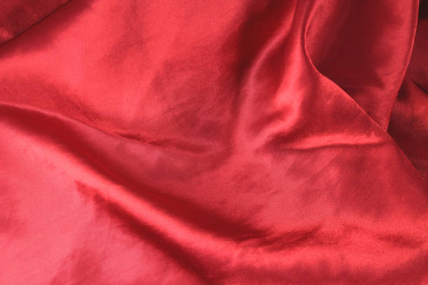 istock Red fabric background texture wave. Pink silk fabric close-up with an overflow of light and a delicate contrast. Symbol of love, sex, passion, tenderness 685772714