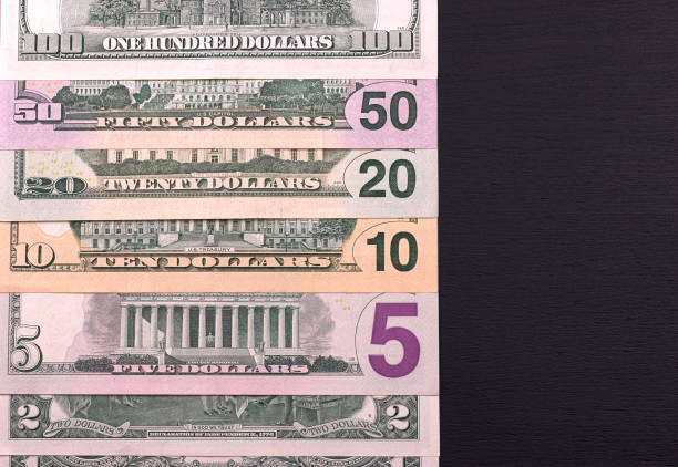 istock Pile of dollar bills of different denominations on black backgrond. 685772982