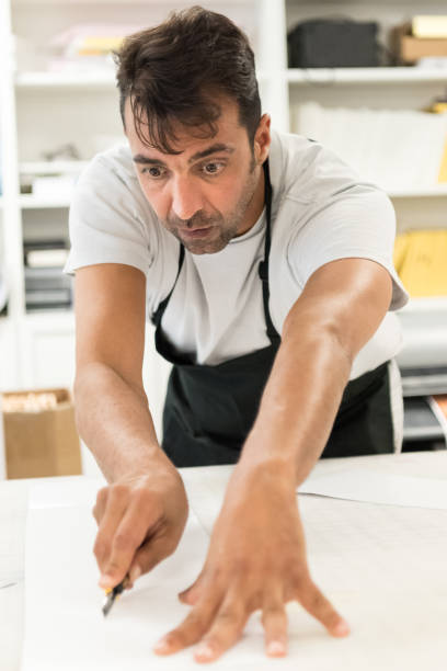 istock Mature man working at his graphic design-printing shop 685774814