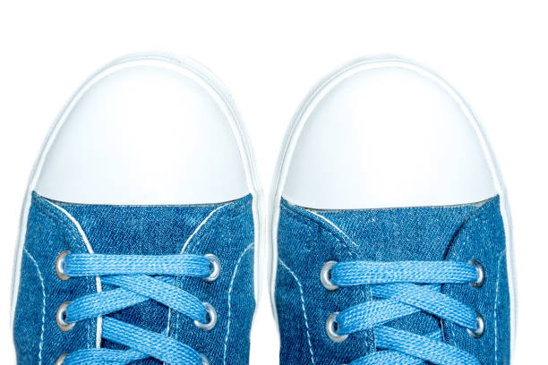 istock Denim sneakers close-up macro texture isolated on white background 685775390