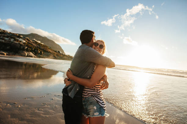 istock Romantic young couple embracing on beach 685775396
