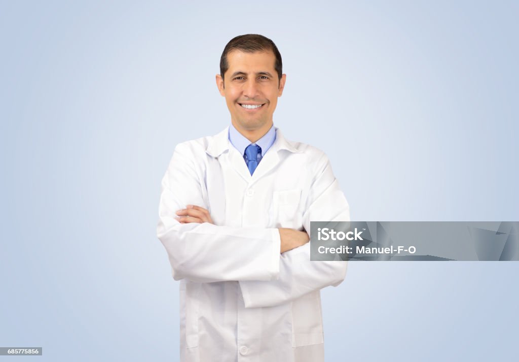 man with lab coat Portrait of a male with lab coat and blue background Pharmacist Stock Photo