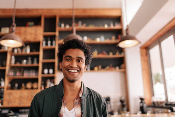 istock Handsome young african guy standing in a coffee shop and smiling 685776188