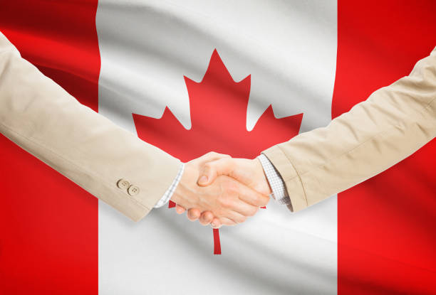 istock Businessmen handshake with flag on background - Canada 685776498