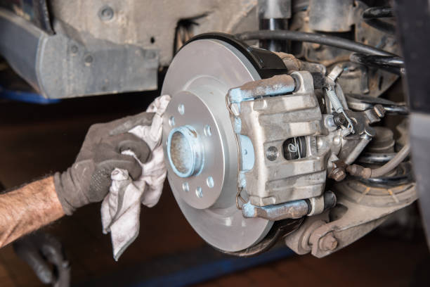 istock Assembler cleans a brake disc after installation in the car repair 685776938