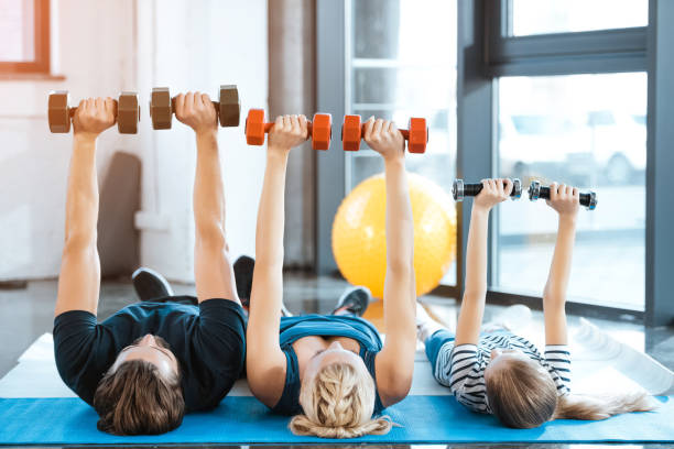 A mom, dad, and child all exercising together.