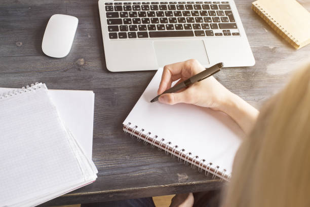 istock Girl writing in notepad closeup 685780804