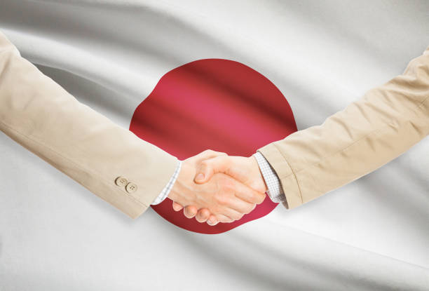 istock Businessmen handshake with flag on background - Japan 685782404