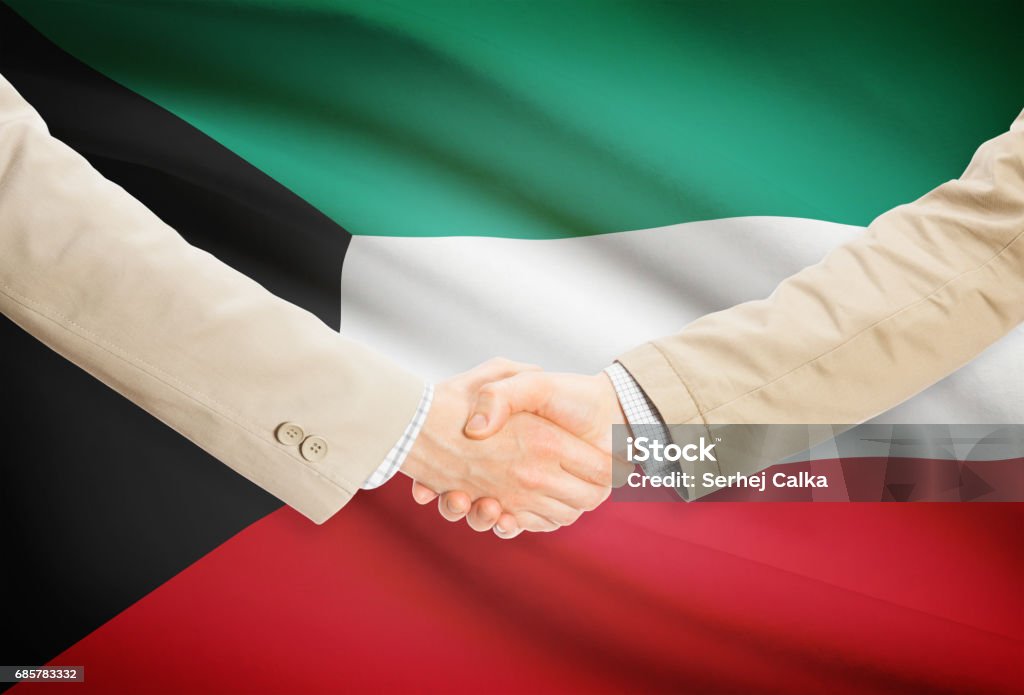 Businessmen handshake with flag on background - Kuwait Businessmen shaking hands with flag on background - Kuwait Agreement Stock Photo