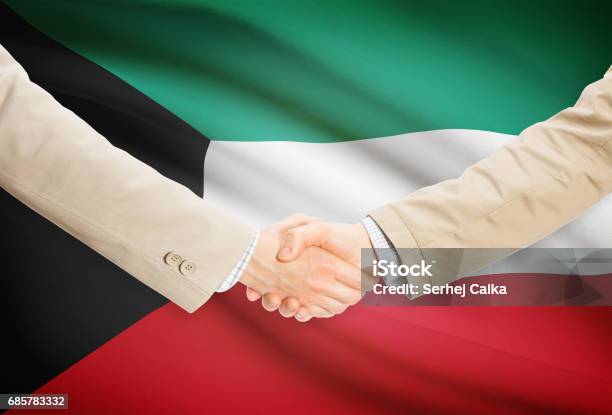 Businessmen Handshake With Flag On Background Kuwait Stock Photo - Download Image Now