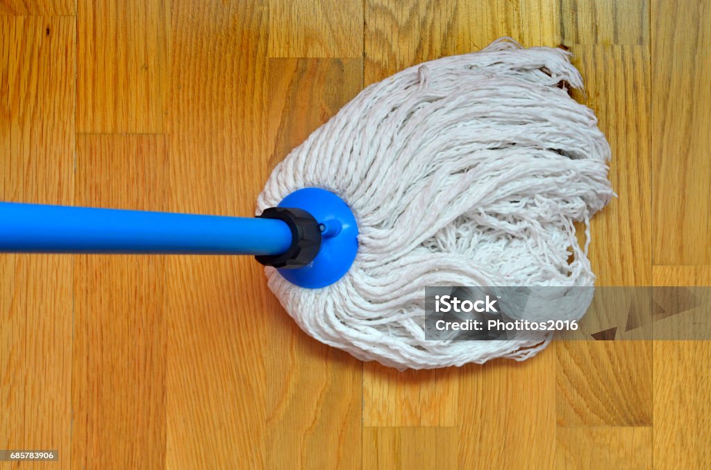 Mop cleaning mop cleaning a wooden ground. Housecleaning concept Broom Stock Photo