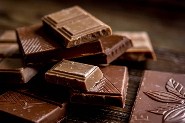 istock black chocolate close up on wooden background 685784762