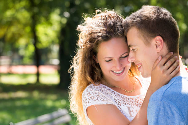 istock young couple embracing in a park 685793588