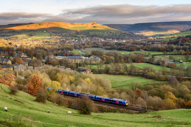 Train in English Countryside Passanger train passing through british countryside near greater Manchester, England. peak district national park photos stock pictures, royalty-free photos & images
