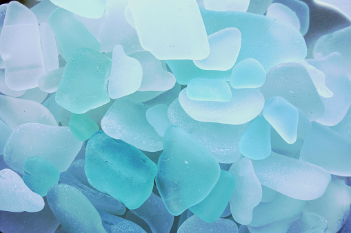 Naturally created sea glass in multiple colors, close up, simple settings