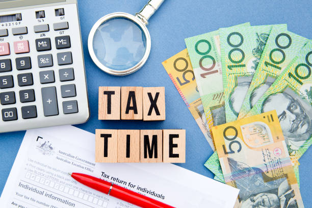 Tax Time - Australia Tax Time - Australia - wooden letters with tax form, magnifying glass, money and calculator tax season photos stock pictures, royalty-free photos & images