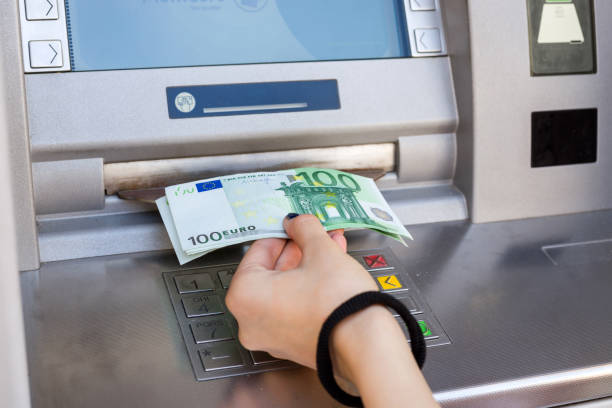 istock woman hand taking out euro banknotes from atm 685796716
