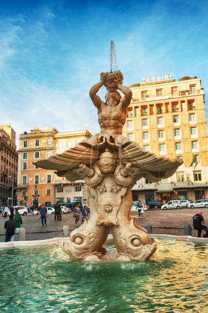 Triton Fountain in Rome Rome, Italy - April 25, 2014. A view of the Triton Fountain in the Piazza Barberini in Rome, Italy. People are walking through the square with the Bernini Hotel in the background. triton greek god stock pictures, royalty-free photos & images