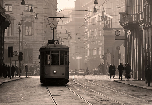 Historical tram in the city center of Milan, Italy, in brown sepia tone