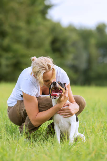 istock woman plays with her dog 685798752